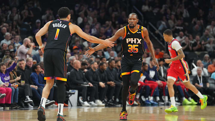 Feb 28, 2025; Phoenix, Arizona, USA; Phoenix Suns forward Kevin Durant (35) and Phoenix Suns guard Devin Booker (1) slap hands against the New Orleans Pelicans during the first half at Footprint Center. Mandatory Credit: Joe Camporeale-Imagn Images