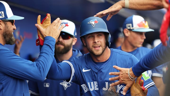 Dunedin, Florida, USA;  Toronto Blue Jays third base Ernie Clement (22) is congratulated after scoring a run during the second inning against the New York Yankees  at TD Ballpark.