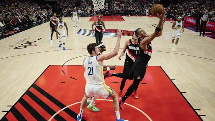 Apr 11, 2025; Portland, Oregon, USA; Portland Trail Blazers forward Toumani Camara (33) scores a layup during the first half against Golden State Warriors center Quinten Post (21) at Moda Center. Mandatory Credit: Troy Wayrynen-Imagn Images