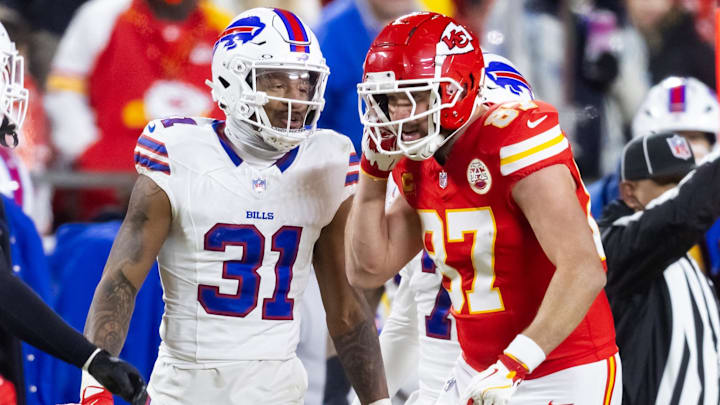 Kansas City Chiefs tight end Travis Kelce (87) reacts as he talks to Buffalo Bills cornerback Rasul Douglas (31) during the AFC Championship game at GEHA Field at Arrowhead Stadium. 