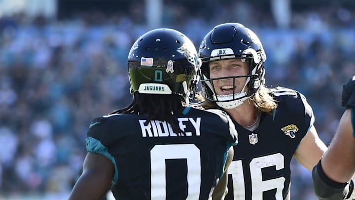 Jacksonville Jaguars quarterback Trevor Lawrence (16) greets teammate wide receiver Calvin Ridley