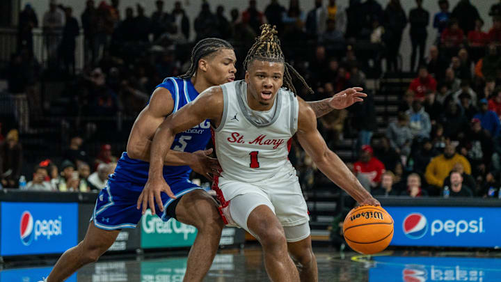 Orchard Lake Saint Mary’s Trey McKenney (1) dribbles through IMG Academy’s Darius Acuff (5) at Oakland University in Rochester on Thursday, Jan. 9, 2025. He suffered a broken bone in his hand during this game which kept him out of the lineup for nearly a month.