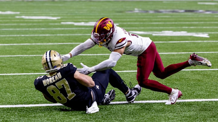 Dec 15, 2024; New Orleans, Louisiana, USA;  New Orleans Saints tight end Foster Moreau (87) catches a touchdown pass to get within 1 point of he Washington Commanders during the second half at Caesars Superdome. Mandatory Credit: Stephen Lew-Imagn Images