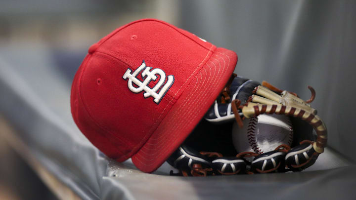Sep 17, 2018; Atlanta, GA, USA; Detailed view of a St. Louis Cardinals hat and glove in the dugout against the Atlanta Braves in the first inning at SunTrust Park. Mandatory Credit: Brett Davis-Imagn Images
