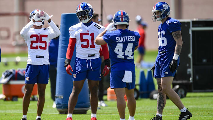May 10, 2025; East Rutherford, NJ, USA; New York Giants cornerback Korie Black (25), linebacker Abdul Carter (51), running back Cam Skattebo (44) and tight end Thomas Fidone II (86) chat during rookie minicamp at Quest Diagnostics Training Center.  