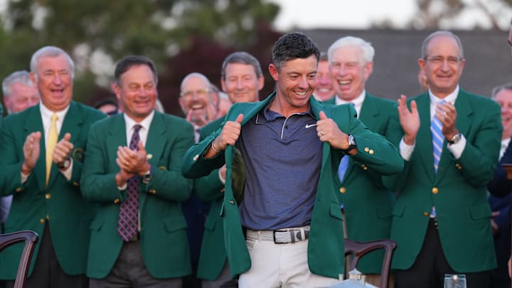 Rory McIlroy celebrates with the green jacket after defeating Justin Rose in a playoff hole to win the 2025 Masters.