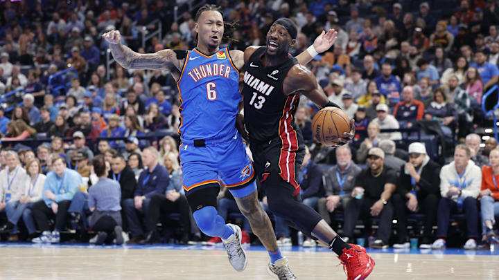 Feb 12, 2025; Oklahoma City, Oklahoma, USA;Miami Heat center Bam Adebayo (13) drives to the basket beside Oklahoma City Thunder forward Jaylin Williams (6) during the second quarter at Paycom Center. Mandatory Credit: Alonzo Adams-Imagn Images