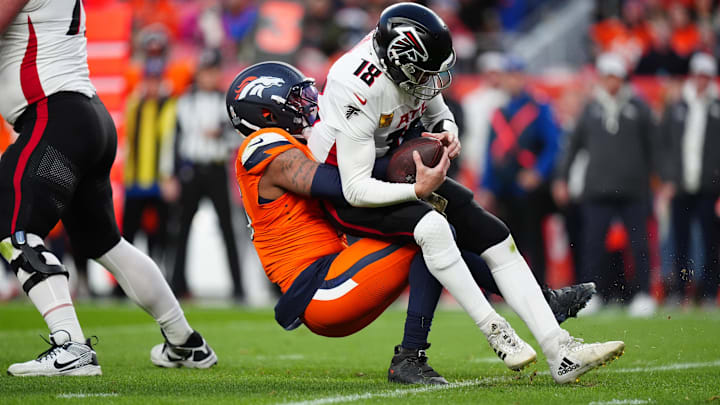Nov 17, 2024; Denver, Colorado, USA; Denver Broncos linebacker Nik Bonitto (15) sacks Atlanta Falcons quarterback Kirk Cousins (18) in the second half at Empower Field at Mile High. Mandatory Credit: Ron Chenoy-Imagn Images Nov 17, 2024; Denver, Colorado, USA; Denver Broncos linebacker Nik Bonitto (15) sacks Atlanta Falcons quarterback Kirk Cousins (18) in the second half at Empower Field at Mile High. Mandatory Credit: Ron Chenoy-Imagn Images