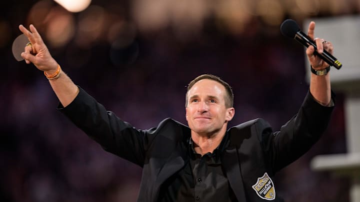 Oct 17, 2024; New Orleans, Louisiana, USA; New Orleans Saints retired quarterback Drew Brees (9) reacts during his hall of fame ceremony at halftime against the Denver Broncos at Caesars Superdome. Mandatory Credit: Matthew Hinton-Imagn Images Oct 17, 2024; New Orleans, Louisiana, USA; New Orleans Saints retired quarterback Drew Brees (9) reacts during his hall of fame ceremony at halftime against the Denver Broncos at Caesars Superdome. Mandatory Credit: Matthew Hinton-Imagn Images