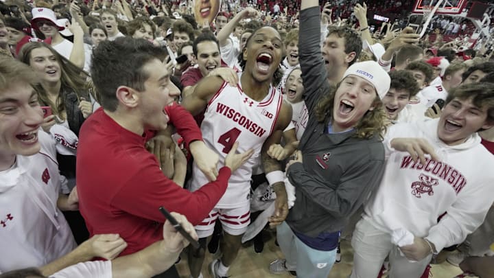 Wisconsin guard Kamari McGee (4) joins fans who stormed the court