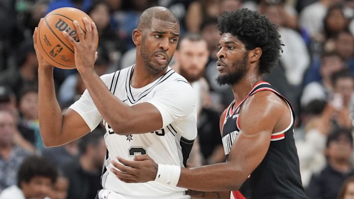 Nov 7, 2024; San Antonio, Texas, USA;  San Antonio Spurs guard Chris Paul (3) keeps the ball from Portland Trail Blazers guard Scoot Henderson (00) in the second half at Frost Bank Center. Mandatory Credit: Daniel Dunn-Imagn Images
