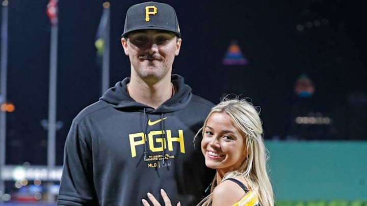 May 11, 2024; Pittsburgh, Pennsylvania, USA;  Pittsburgh Pirates starting pitcher Paul Skenes (30) poses with his girlfriend Louisiana State University gymnast Olivia Dunne (right) after Skenes made his major league debut against the Chicago Cubs at PNC Park. Mandatory Credit: Charles LeClaire-Imagn Images