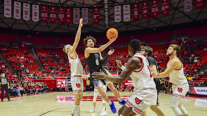Dec 31, 2023; Salt Lake City, Utah, USA; Washington Huskies guard Nate Calmese (8) shoots through Utah Utes defense during the first half at the the Jon M. Huntsman Center. Mandatory Credit: Christopher Creveling-Imagn Images Dec 31, 2023; Salt Lake City, Utah, USA; Washington Huskies guard Nate Calmese (8) shoots through Utah Utes defense during the first half at the the Jon M. Huntsman Center. Mandatory Credit: Christopher Creveling-Imagn Images