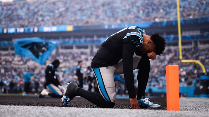 Nov 30, 2025; Charlotte, North Carolina, USA; Carolina Panthers quarterback Bryce Young (9) kneels before the game against the Los Angeles Rams at Bank of America Stadium. Nov 30, 2025; Charlotte, North Carolina, USA; Carolina Panthers quarterback Bryce Young (9) kneels before the game against the Los Angeles Rams at Bank of America Stadium.