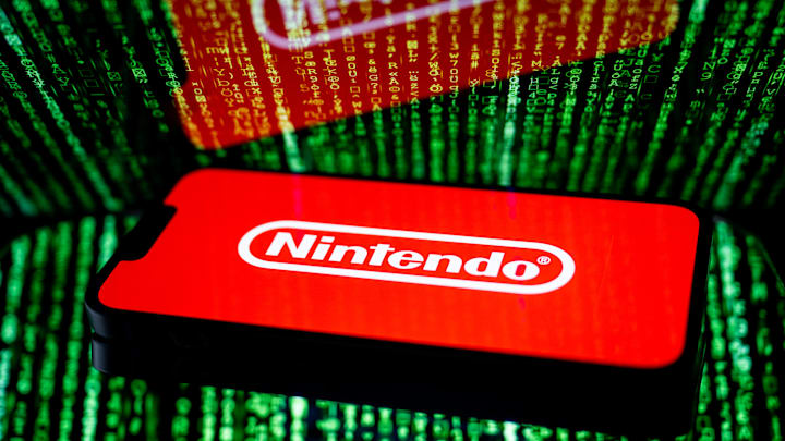 In this photo illustration, a Nintendo logo seen displayed...