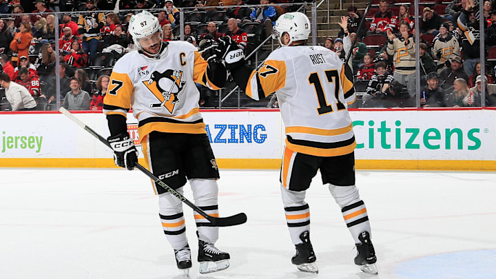 Sidney Crosby (left) fist bumps Bryan Rust (right) during Pittsburgh Penguins v New Jersey Devils