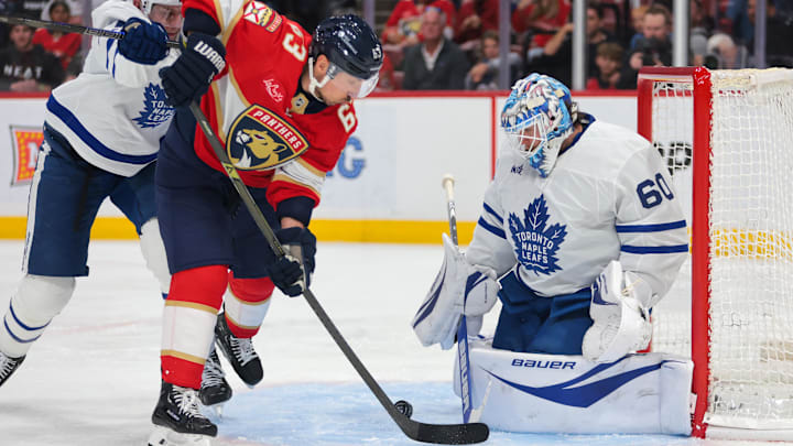 Apr 8, 2025; Sunrise, Florida, USA; Toronto Maple Leafs goaltender Joseph Woll (60) makes a save against Florida Panthers center Brad Marchand (63) during the second period at Amerant Bank Arena. Mandatory Credit: Sam Navarro-Imagn Images