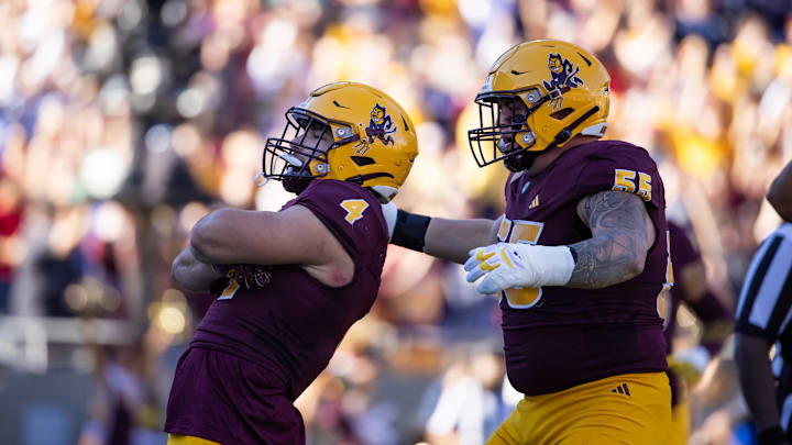 Nov 25, 2023; Tempe, Arizona, USA; Arizona State Sun Devils running back Cam Skattebo (4) celebrates a touchdown with offensive lineman Cade Briggs (55) against the Arizona Wildcats during the Territorial Cup at Mountain America Stadium. Mandatory Credit: Mark J. Rebilas-USA TODAY Sports Nov 25, 2023; Tempe, Arizona, USA; Arizona State Sun Devils running back Cam Skattebo (4) celebrates a touchdown with offensive lineman Cade Briggs (55) against the Arizona Wildcats during the Territorial Cup at Mountain America Stadium. Mandatory Credit: Mark J. Rebilas-USA TODAY Sports