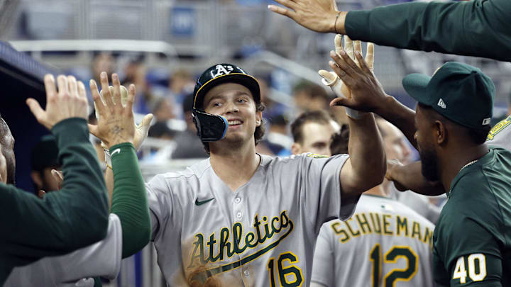 May 4, 2025; Miami, Florida, USA;  Oakland Athletics first baseman Nick Kurtz (16) is greeted in the dugout by teammates after scoring against the Miami Marlins during the ninth inning at loanDepot Park. Mandatory Credit: Rhona Wise-Imagn Images