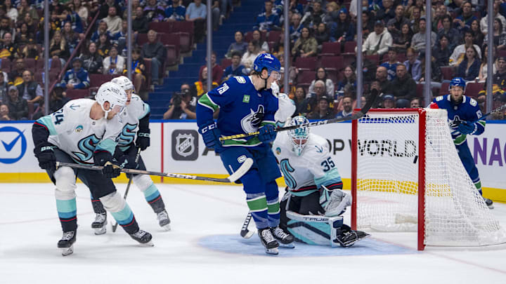 Sep 24, 2024; Vancouver, British Columbia, CAN; Seattle Kraken defenseman Jamie Oleksiak (24) and goalie Joey Daccord (35) watch the shot from Vancouver Canucks forward Sammy Blais (79) hit the post during the first period at Rogers Arena. Mandatory Credit: Bob Frid-Imagn Images