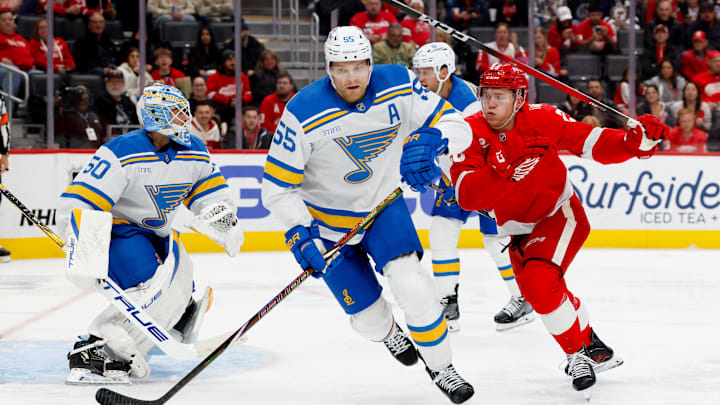 Oct 25, 2025; Detroit, Michigan, USA;  St. Louis Blues defenseman Colton Parayko (55) and Detroit Red Wings right wing Michael Brandsegg-Nygård (28) go after the puck in the second period at Little Caesars Arena. Mandatory Credit: Rick Osentoski-Imagn Images