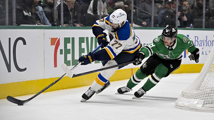 Dec 14, 2024; Dallas, Texas, USA; St. Louis Blues defenseman Pierre-Olivier Joseph (77) and Dallas Stars center Sam Steel (18) in action during the game between the Dallas Stars and the St. Louis Blues at American Airlines Center. Mandatory Credit: Jerome Miron-Imagn Images