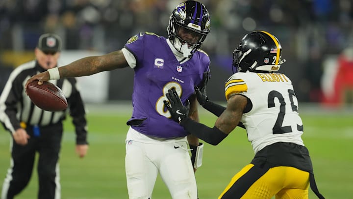 Jan 11, 2025; Baltimore, Maryland, USA; Baltimore Ravens quarterback Lamar Jackson (8) runs against Pittsburgh Steelers safety DeShon Elliott (25) in the second quarter in an AFC wild card game at M&T Bank Stadium. Mandatory Credit: Mitch Stringer-Imagn Images