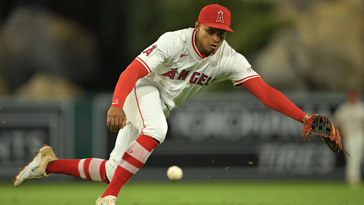 Sep 23, 2025; Anaheim, California, USA;  Kansas City Royals second baseman Adam Frazier (26) singles past Los Angeles Angels second baseman Christian Moore (4) during the fourth inning at Angel Stadium. Mandatory Credit: Jayne Kamin-Oncea-Imagn Images