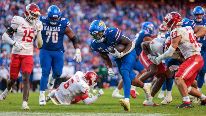 Oct 19, 2024; Kansas City, Missouri, USA; Kansas Jayhawks running back Devin Neal (4) carries the ball into the end zone for a touchdown against the Houston Cougars during the fourth quarter at GEHA Field at Arrowhead Stadium. Mandatory Credit: William Purnell-Imagn Images Oct 19, 2024; Kansas City, Missouri, USA; Kansas Jayhawks running back Devin Neal (4) carries the ball into the end zone for a touchdown against the Houston Cougars during the fourth quarter at GEHA Field at Arrowhead Stadium. Mandatory Credit: William Purnell-Imagn Images