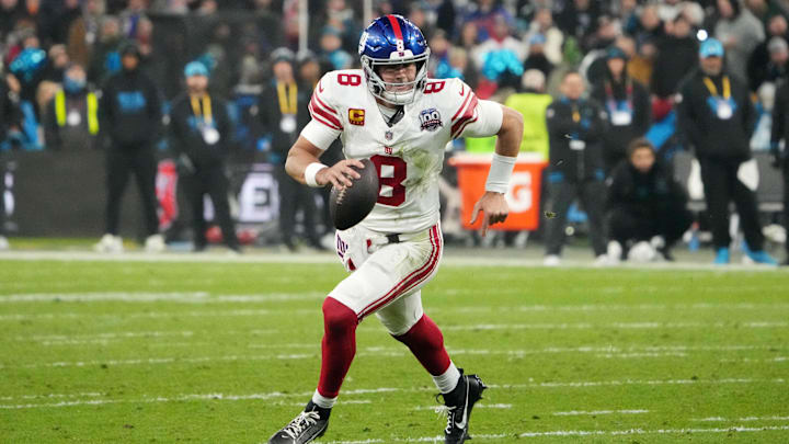 Nov 10, 2024; Munich, Germany; New York Giants quarterback Daniel Jones (8) carries the ball against the New York Giants in the second half during the 2024 NFL Munich Game at Allianz Arena. 