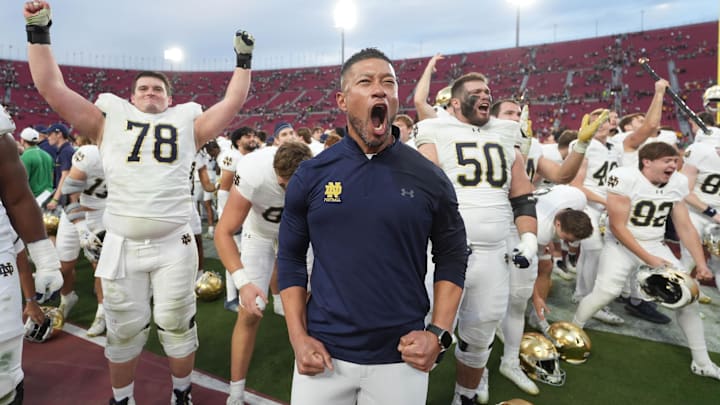 Nov 30, 2024; Los Angeles, California, USA; Notre Dame Fighting Irish head coach Marcus Freeman celebrates with players at the end of the game against the Southern California Trojans at United Airlines Field at Los Angeles Memorial Coliseum. Mandatory Credit: Kirby Lee-Imagn Images