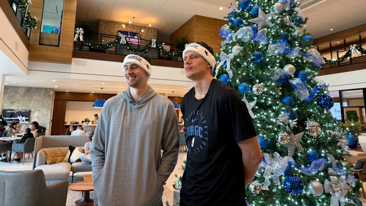 Orlando Magic brothers Franz and Moe Wagner pose during their Foundation for Foster Children holiday party at the AdventHealth Training Center.