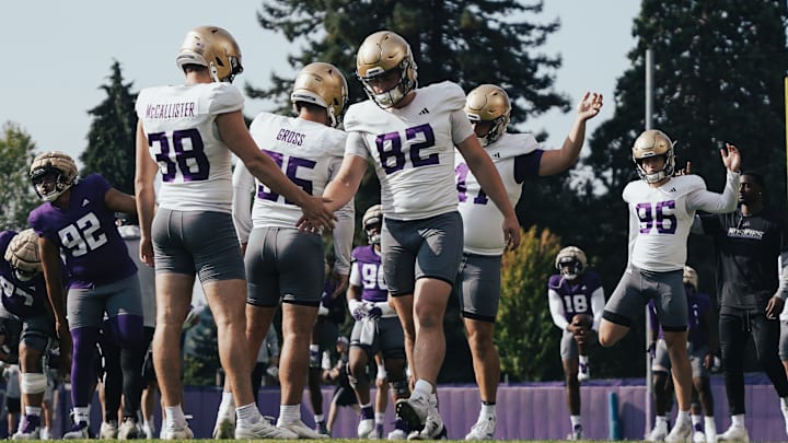 Former UW snapper Caleb Johnston (82) shakes hands with punter Jack McCallister, now both in the transfer portal.