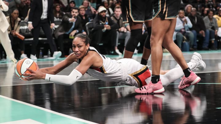 Oct 15, 2023; Brooklyn, New York, USA; Las Vegas Aces forward A'ja Wilson (22) falls to the floor with the ball