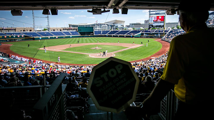 An usher holds a sign stopping fans from walking down the aisle during the championship game of the Big Ten Baseball Tournament between Iowa and Maryland, Sunday, May 28, 2023, at Charles Schwab Field in Omaha, Neb.