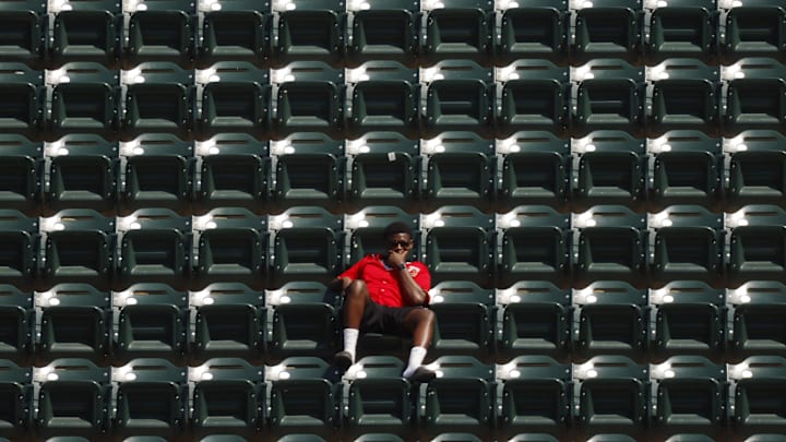 Jul 6, 2025; Minneapolis, Minnesota, USA; A Minnesota Twins fan watches as they play the Tampa Bay Rays in the 10th inning at Target Field. Mandatory Credit: Bruce Kluckhohn-Imagn Images