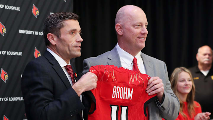 U of L Athletic Director Josh Heird, left, presented Jeff Brohm with a jersey after he was announced as the new head football coach at Cardinal Stadium in Louisville, Ky. on Dec. 8, 2022.

Brohm08 Sam