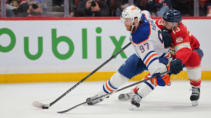 Jun 17, 2025; Sunrise, Florida, USA; Edmonton Oilers center Connor McDavid (97) controls the puck defended by Florida Panthers center Sam Reinhart (13) during the first period in game six of the 2025 Stanley Cup Final at Amerant Bank Arena. Mandatory Credit: Sam Navarro-Imagn Images