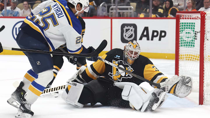 Mar 13, 2025; Pittsburgh, Pennsylvania, USA;  Pittsburgh Penguins goaltender Tristan Jarry (35) makes as save against St. Louis Blues center Jordan Kyrou (25) during the second period at PPG Paints Arena. Mandatory Credit: Charles LeClaire-Imagn Images
