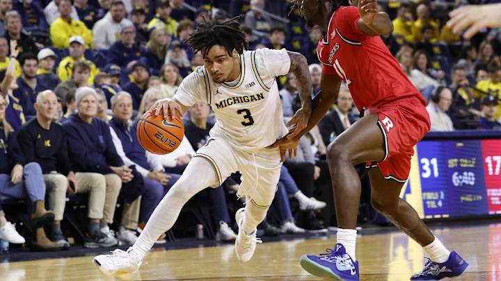 Dec 6, 2025; Ann Arbor, Michigan, USA; Michigan Wolverines guard Elliot Cadeau (3) dribbles defended by Rutgers Scarlet Knights forward Chris Nwuli (11) in the first half at Crisler Center. Mandatory Credit: Rick Osentoski-Imagn Images Dec 6, 2025; Ann Arbor, Michigan, USA; Michigan Wolverines guard Elliot Cadeau (3) dribbles defended by Rutgers Scarlet Knights forward Chris Nwuli (11) in the first half at Crisler Center. Mandatory Credit: Rick Osentoski-Imagn Images