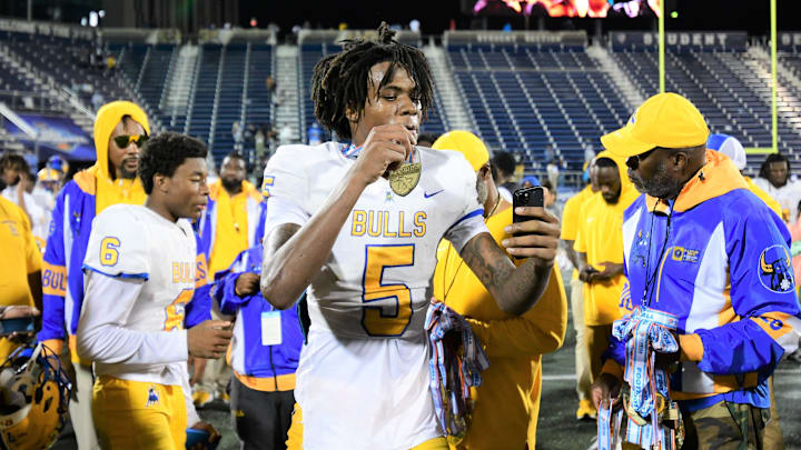 Miami Northwestern's Calvin Russell Jr. takes a selfie with his state medal after his team won the Class 3A championship against Raines on Dec. 14, 2024.