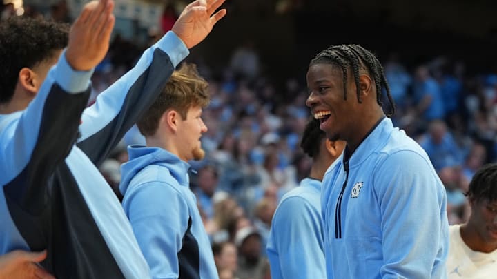 Feb 14, 2026; Chapel Hill, North Carolina, USA; North Carolina Tar Heels guard Isaiah Denis (5) and forward Caleb Wilson (8) react on the bench in the second half at Dean E. Smith Center. Mandatory Credit: Bob Donnan-Imagn Images