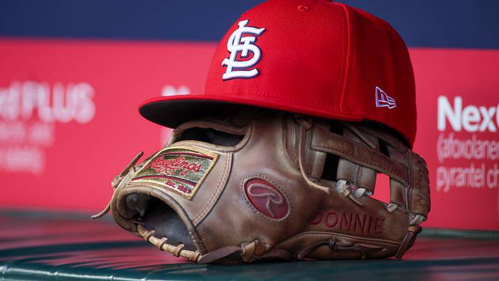 Apr 21, 2025; Atlanta, Georgia, USA; A St. Louis Cardinals hat and glove in the dugout against the Atlanta Braves in the first inning at Truist Park. Mandatory Credit: Brett Davis-Imagn Images