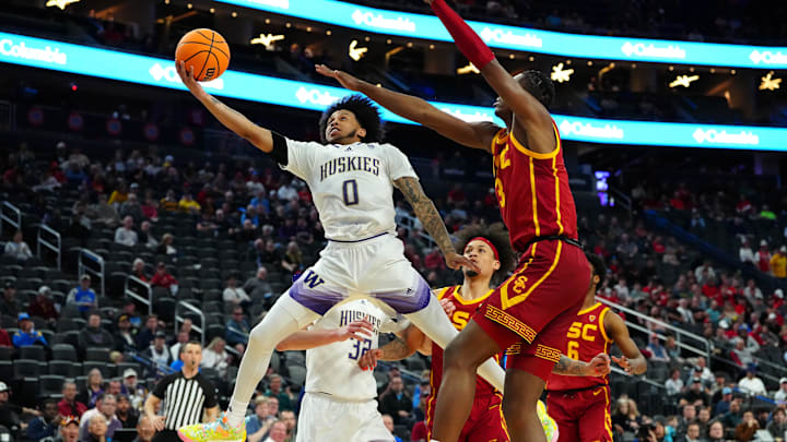 Then Huskies guard Koren Johnson (0) goes for a lay-in against USC in 2024. 