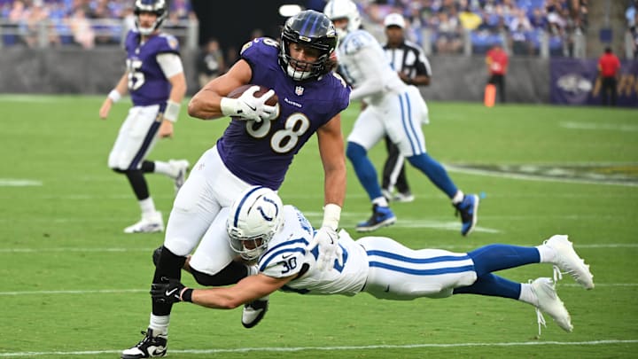 Aug 7, 2025; Baltimore, Maryland, USA; Baltimore Ravens tight end Charlie Kolar (88) is tackled by Indianapolis Colts safety Hunter Wohler (30) during the first quarter at M&T Bank Stadium. Mandatory Credit: Rafael Suanes-Imagn Images