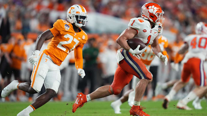 Dec 30, 2022; Miami Gardens, FL, USA; Clemson Tigers running back Will Shipley (1) runs the ball ahead of Tennessee Volunteers defensive lineman James Pearce Jr. (27) during the second half of the 2022 Orange Bowl at Hard Rock Stadium. Mandatory Credit: Jasen Vinlove-Imagn Images