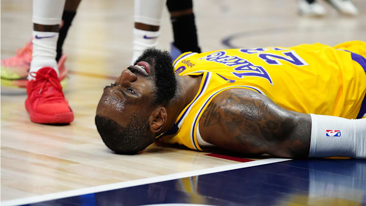 Apr 22, 2024: Los Angeles Lakers forward LeBron James lays on the court in the second quarter against the Denver Nuggets during Game Two.
