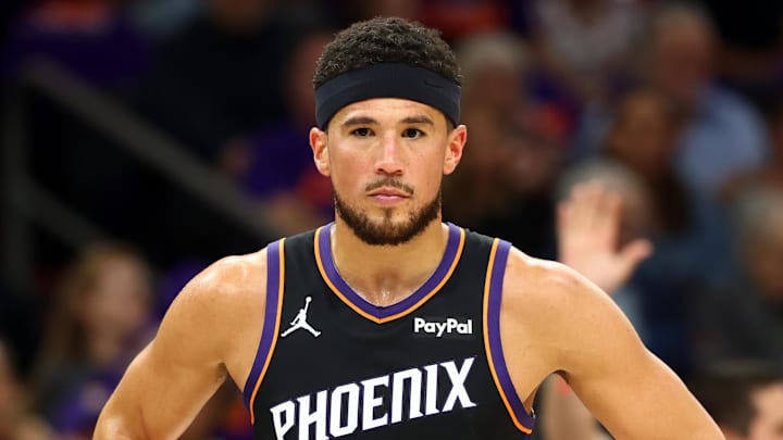 Apr 14, 2026; Phoenix, Arizona, USA; Phoenix Suns guard Devin Booker (1) against the Portland Trail Blazers during the play-in rounds of the 2026 NBA Playoffs at Mortgage Matchup Center. Mandatory Credit: Mark J. Rebilas-Imagn Images
