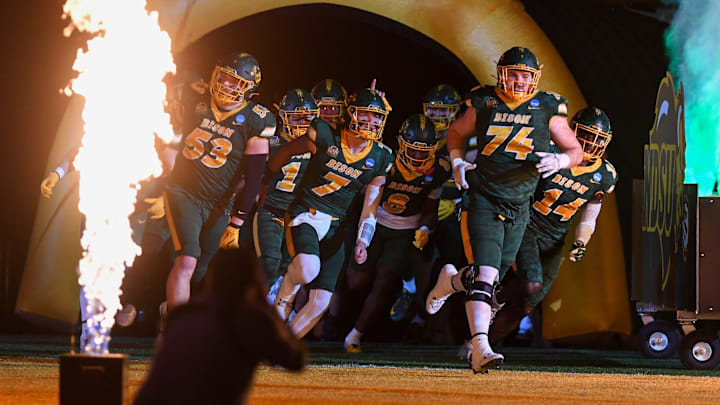 The North Dakota State Bison football team runs onto the field before an FCS Playoff game against the South Dakota State Jackrabbits