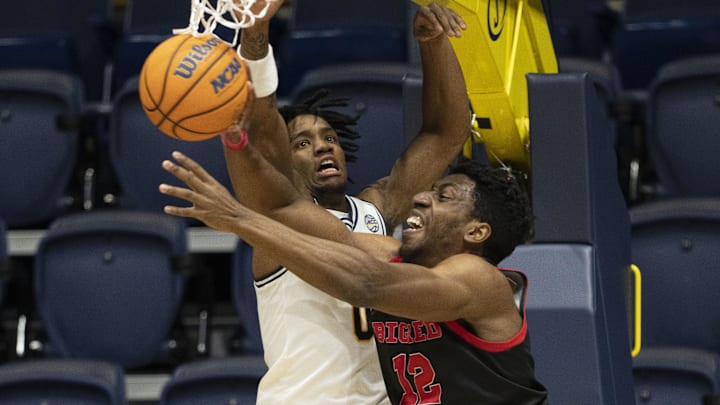 Cornell Big Red forward AK Okereke (12) passes the basketball against California Golden Bears guard Jeremiah Wilkinson (0) during the first half at Haas Pavilion. Cornell Big Red forward AK Okereke (12) passes the basketball against California Golden Bears guard Jeremiah Wilkinson (0) during the first half at Haas Pavilion.